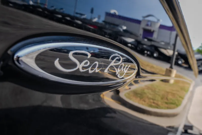 Slide: The Image of Close-up of 2006 Sea Ray 270 SLX logo on a sleek black surface. - 2