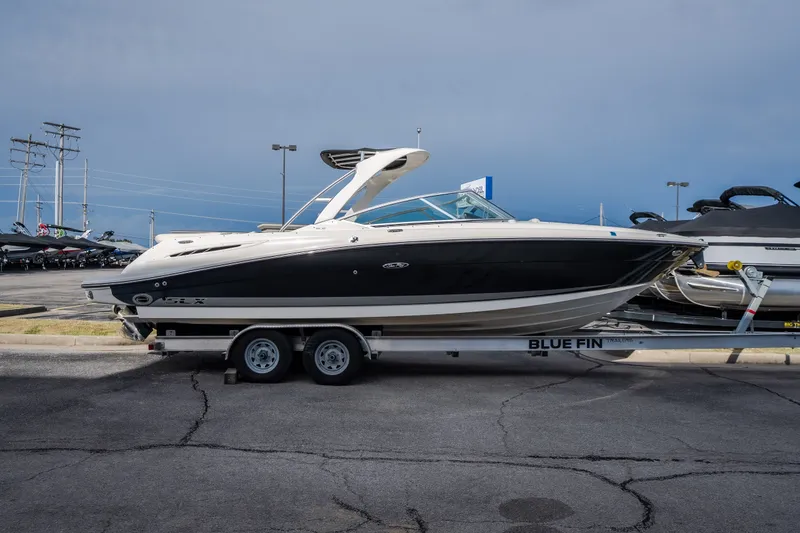 Slide: The Image of 2006 Sea Ray 270 SLX boat on trailer in parking lot, side view. - 3