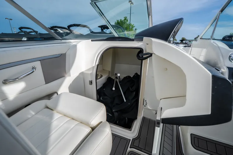 Slide: The Image of 2006 Sea Ray 270 SLX boat interior with open storage compartment and seating. - 24