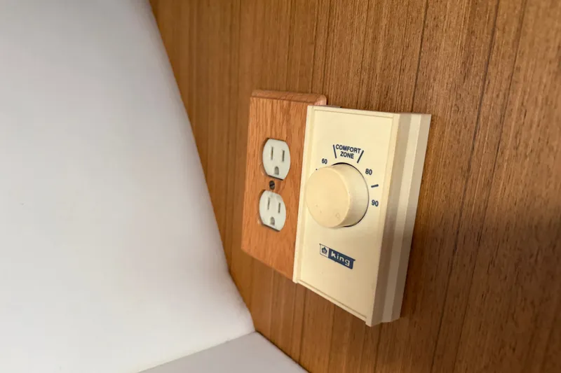 Slide: The Image of Thermostat and outlet on wooden panel in 2001 Bayliner 3788 Command Bridge Motoryacht. - 61