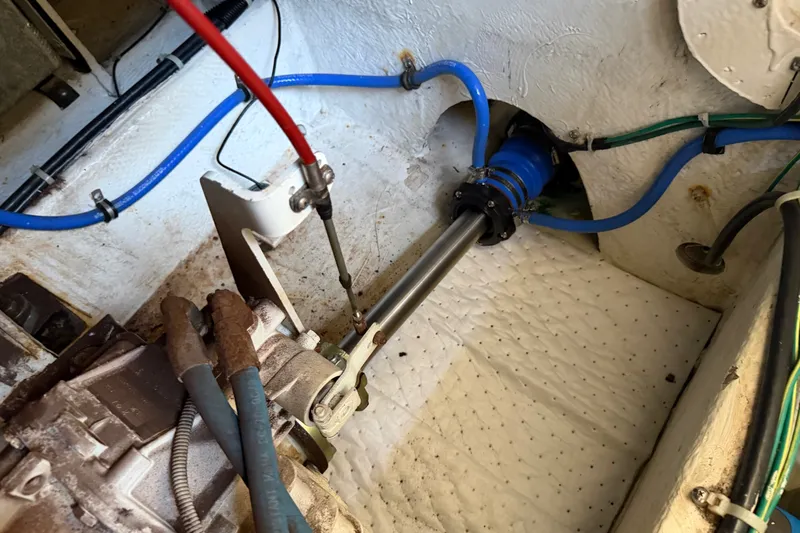 Slide: The Image of Engine compartment of a 2001 Bayliner 3788 Command Bridge Motoryacht, showing mechanical components and hoses. - 58