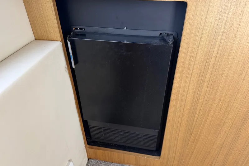 Slide: The Image of Built-in refrigerator on 2001 Bayliner 3788 Command Bridge Motoryacht, wooden paneling. - 11