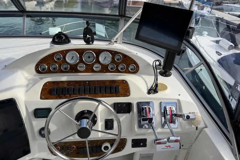 Slide: The Image of Helm of 2001 Bayliner 3788 Command Bridge Motoryacht with gauges, controls, and navigation screen. - 47