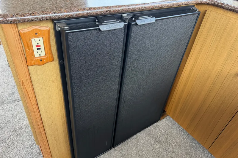 Slide: The Image of 2001 Bayliner 3788 Command Bridge Motoryacht interior with dual-door refrigerator and power outlet. - 14