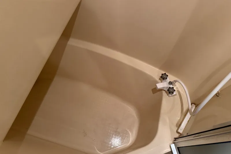 Slide: The Image of Shower area in 2001 Bayliner 3788 Command Bridge Motoryacht, featuring dual faucet controls. - 33