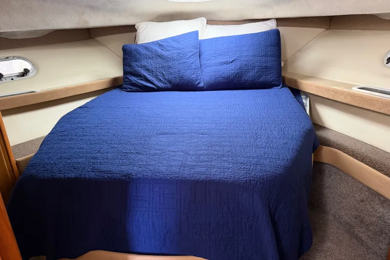 Slide: The Image of Cozy cabin interior of 2001 Bayliner 3788 Command Bridge Motoryacht with blue bedding. - 24