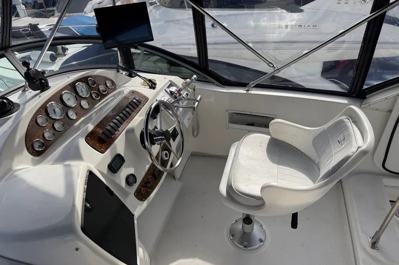 Slide: The Image of 2001 Bayliner 3788 Command Bridge Motoryacht helm with steering wheel and control panel. - 45
