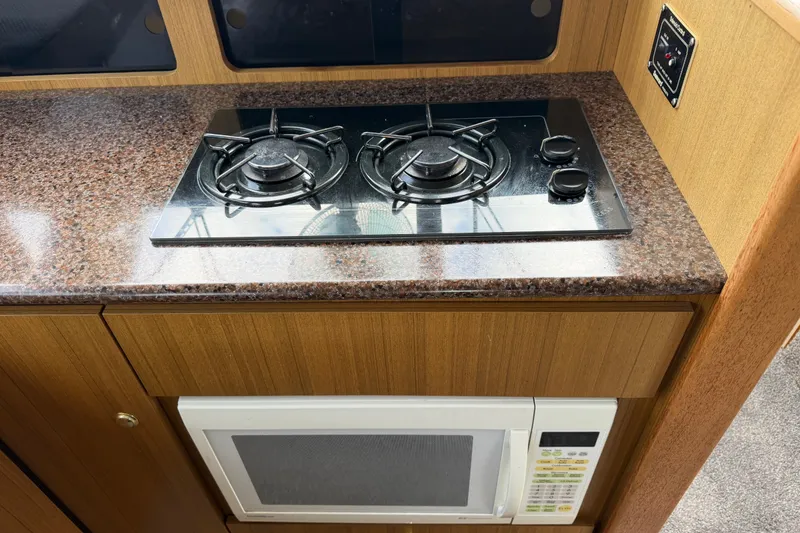 Slide: The Image of Kitchen area of 2001 Bayliner 3788 yacht with stove and microwave. - 16