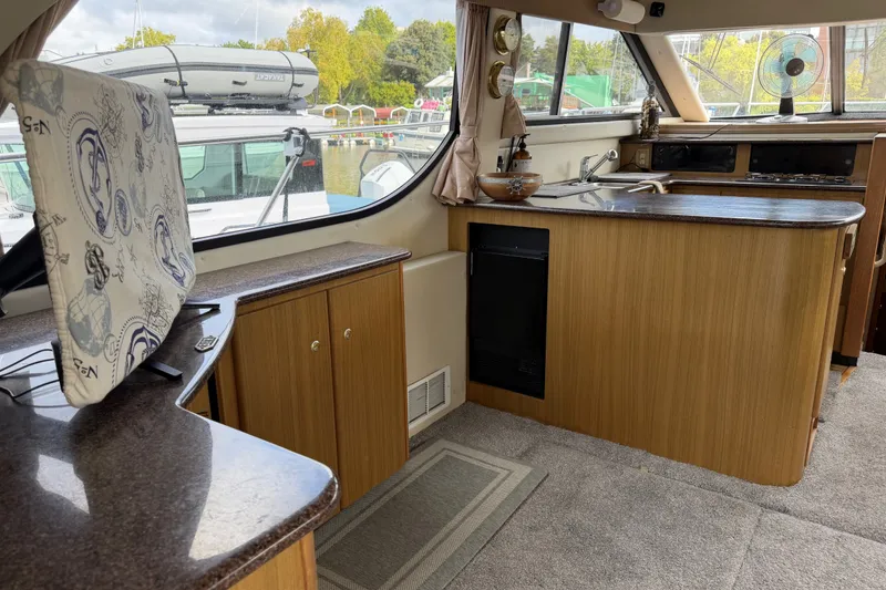 Slide: The Image of Interior of 2001 Bayliner 3788 Command Bridge Motoryacht with kitchen and seating area. - 10
