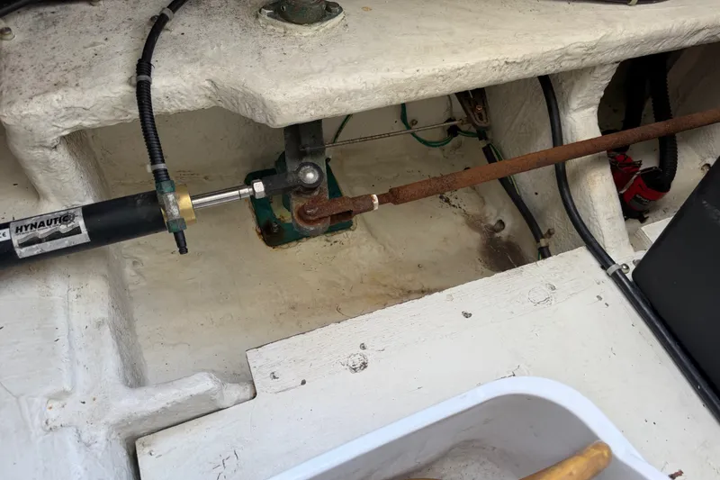 Slide: The Image of 2001 Bayliner 3788 Command Bridge Motoryacht steering mechanism with hydraulic components and rusted rod. - 60