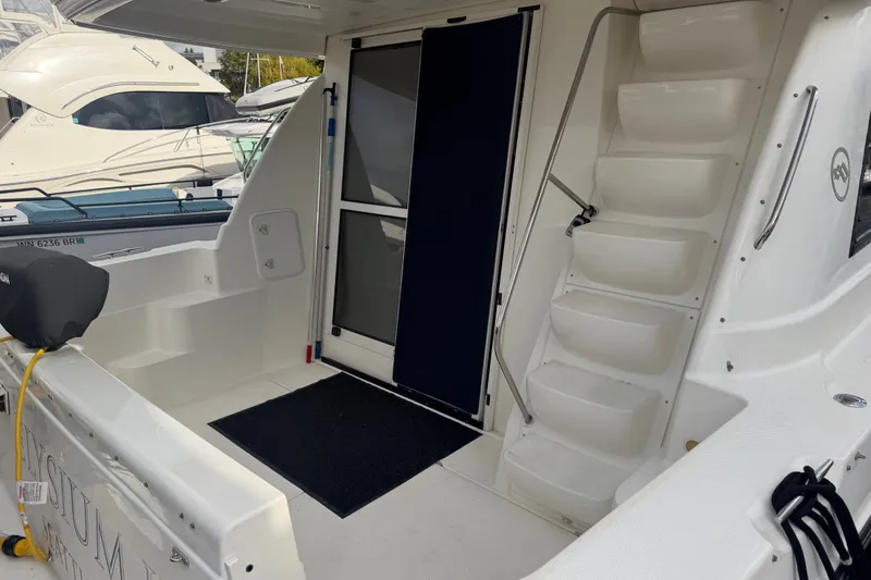 Slide: The Image of 2001 Bayliner 3788 Command Bridge Motoryacht with stairs and covered entrance. - 4