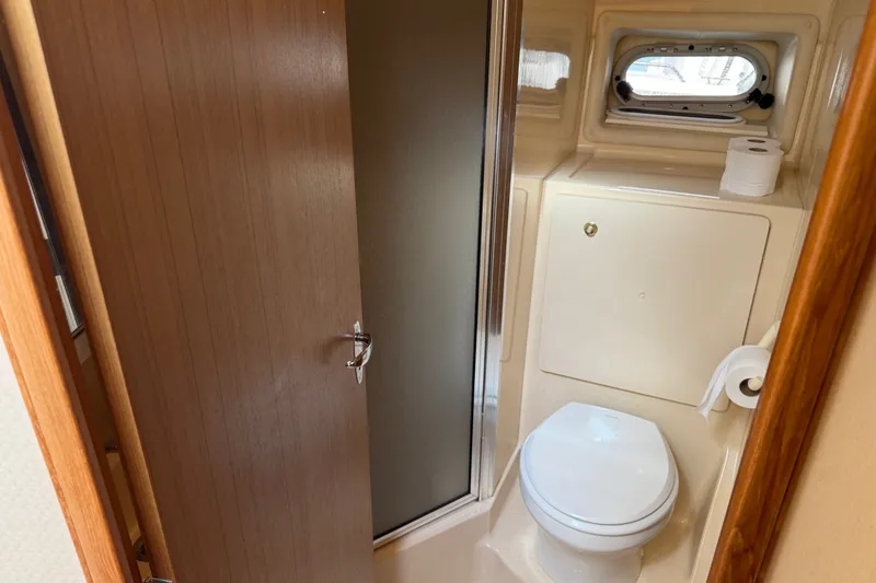 Slide: The Image of 2001 Bayliner 3788 Command Bridge Motoryacht bathroom with toilet and shower. - 31