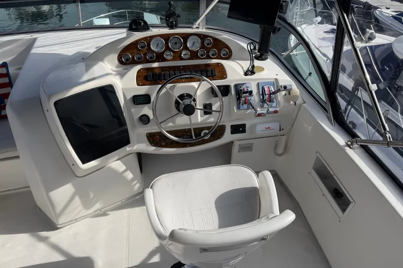Slide: The Image of 2001 Bayliner 3788 Command Bridge Motoryacht helm with steering wheel and control panel. - 46