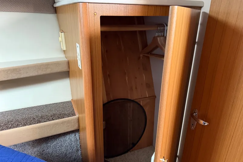 Slide: The Image of Interior of 2001 Bayliner 3788 yacht showing wooden closet and carpeted stairs. - 27