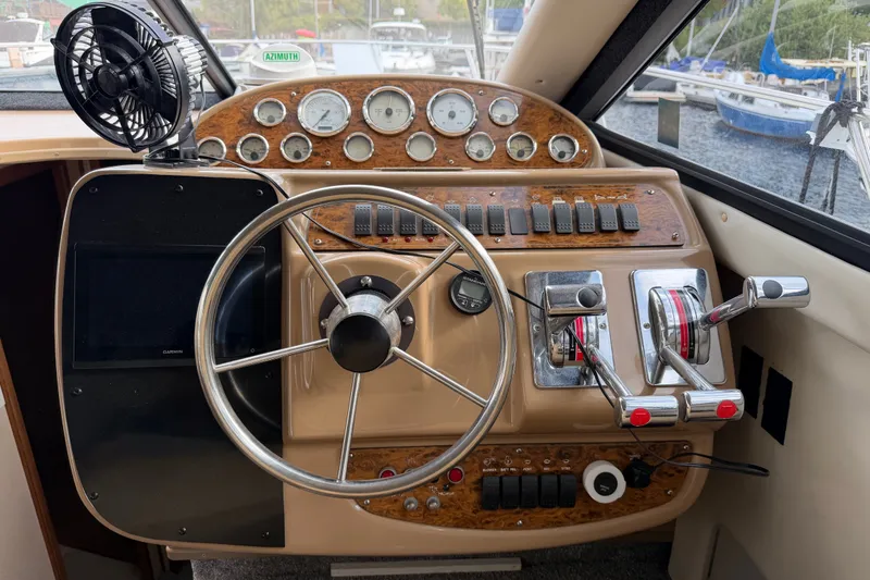 Slide: The Image of 2001 Bayliner 3788 Command Bridge Motoryacht helm with steering wheel and control panel. - 20