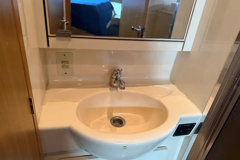 Slide: The Image of Bathroom sink in 2001 Bayliner 3788 Command Bridge Motoryacht, featuring a modern faucet and mirror. - 35