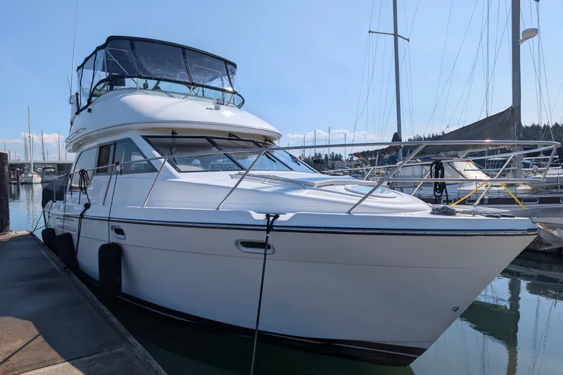The Image of 2001 Bayliner 3788 Command Bridge Motoryacht docked at marina under clear sky. - 0