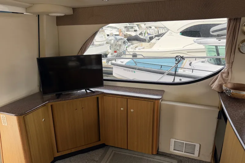 Slide: The Image of Interior of 2001 Bayliner 3788 Command Bridge Motoryacht with TV and marina view. - 9