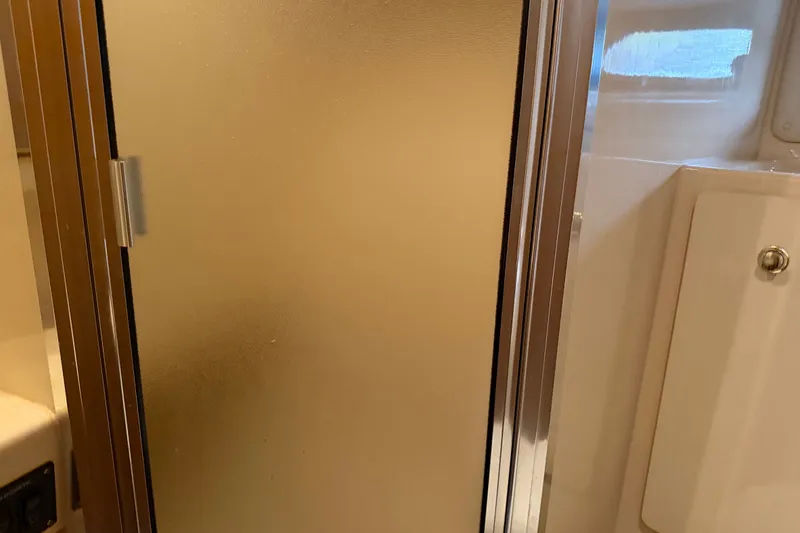Slide: The Image of 2001 Bayliner 3788 Command Bridge Motoryacht bathroom with frosted shower door. - 32
