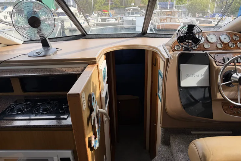 Slide: The Image of 2001 Bayliner 3788 Command Bridge Motoryacht interior with helm, stove, and Garmin navigation system. - 22