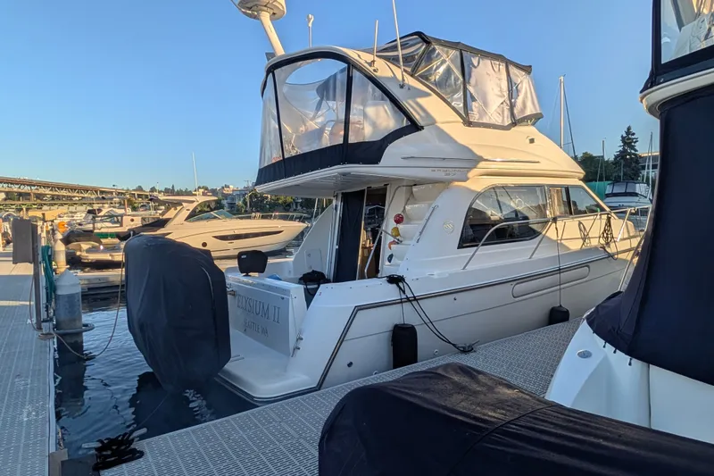 Slide: The Image of 2001 Bayliner 3788 Command Bridge Motoryacht docked at marina under clear sky. - 1