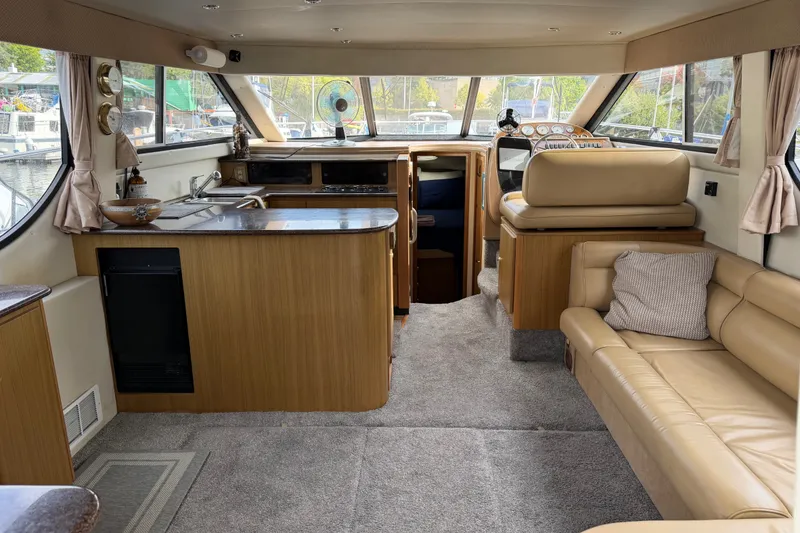Slide: The Image of Interior of 2001 Bayliner 3788 Command Bridge Motoryacht with beige seating and wood accents. - 5