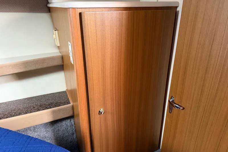 Slide: The Image of 2001 Bayliner 3788 Command Bridge Motoryacht interior with wooden cabinet and carpeted steps. - 26