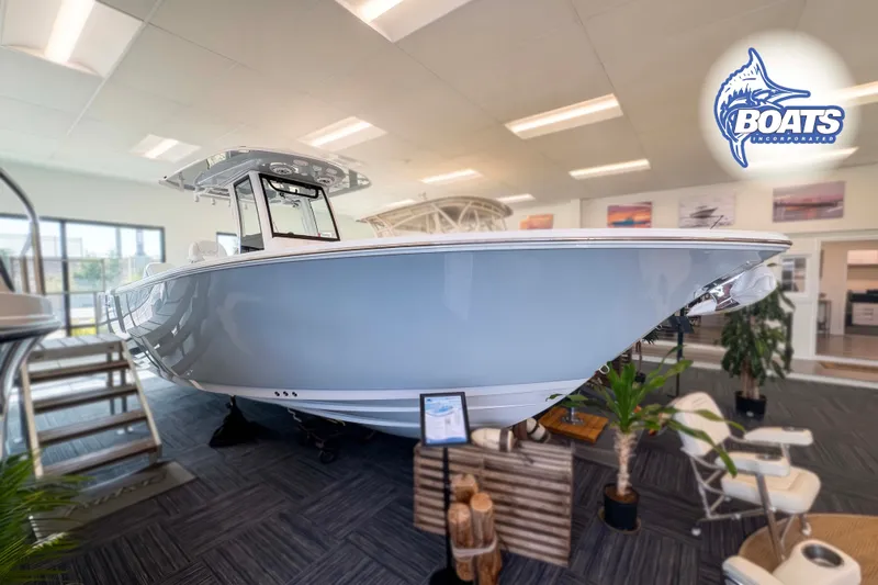 The Image of 2027 Sportsman Heritage 261 Center Console boat displayed indoors at Boats Incorporated showroom. - 0