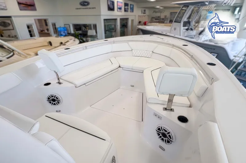 Slide: The Image of 2027 Sportsman Heritage 261 Center Console boat interior with white seating and modern design. - 3