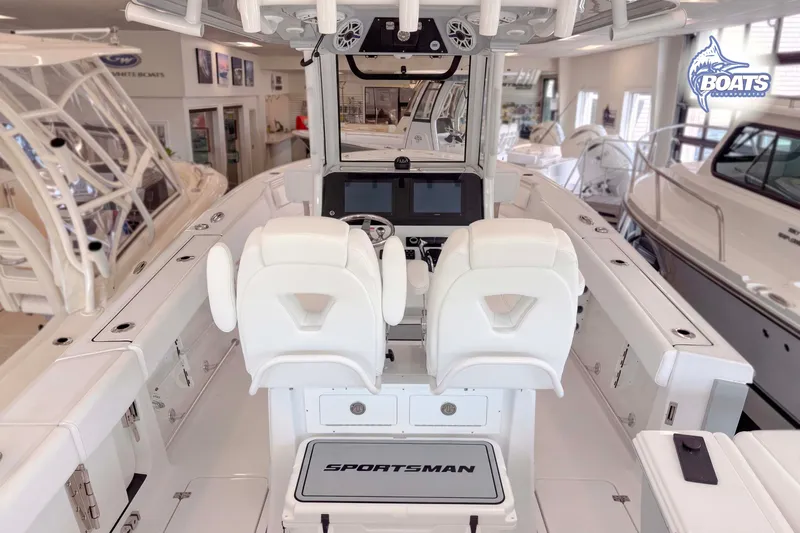 Slide: The Image of 2027 Sportsman Heritage 261 Center Console boat interior with dual white captain seats. - 10