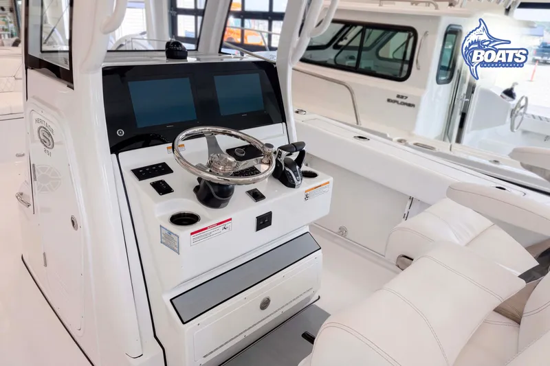 Slide: The Image of 2027 Sportsman Heritage 261 Center Console boat interior with modern helm and dual screens. - 6