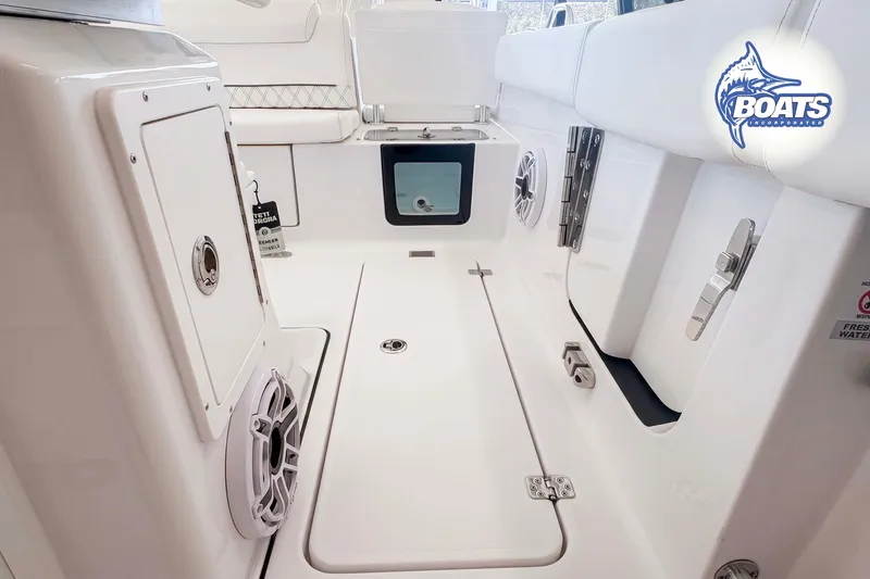 Slide: The Image of Interior view of 2027 Sportsman Heritage 261 Center Console boat, featuring sleek white design and modern amenities. - 8