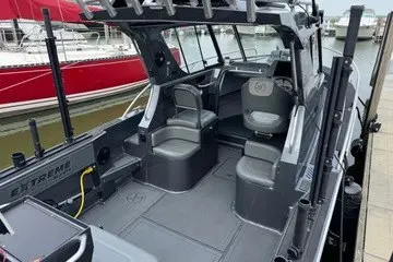 Slide: The Image of 2022 Extreme 745 WA boat interior with seating and helm, docked at marina. - 3