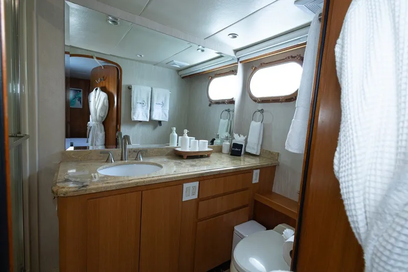 Slide: The Image of Luxurious bathroom on 2004 Broward 110 yacht with elegant fixtures and wooden cabinetry. - 14