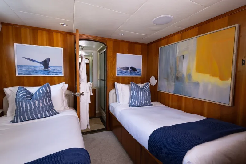 Slide: The Image of Luxurious twin cabin on 2004 Broward 110 yacht with nautical decor and modern art. - 16