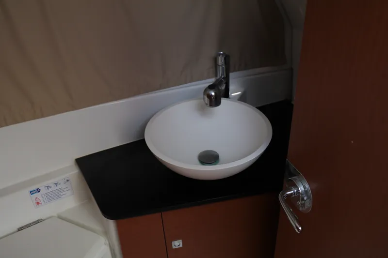 Slide: The Image of 2017 Jeanneau NC 895 bathroom sink with modern faucet and countertop. - 14