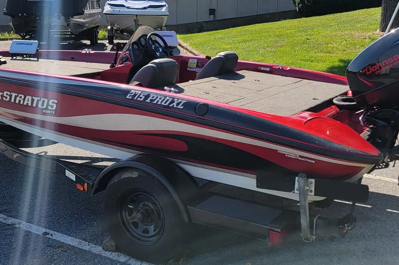 Slide: The Image of 2004 Stratos 275 Pro XL boat with Johnson outboard motor on trailer. - 15