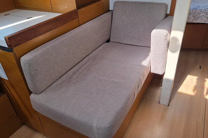 Slide: The Image of Interior of 2020 Jeanneau Sun Odyssey 410 with a comfortable gray sofa. - 36