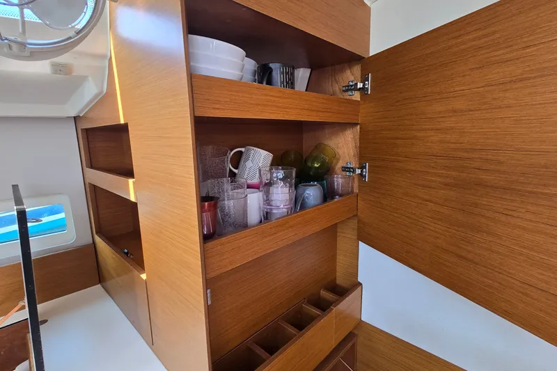 Slide: The Image of Wooden cabinet with dishes and glasses inside a 2020 Jeanneau Sun Odyssey 410 yacht. - 45