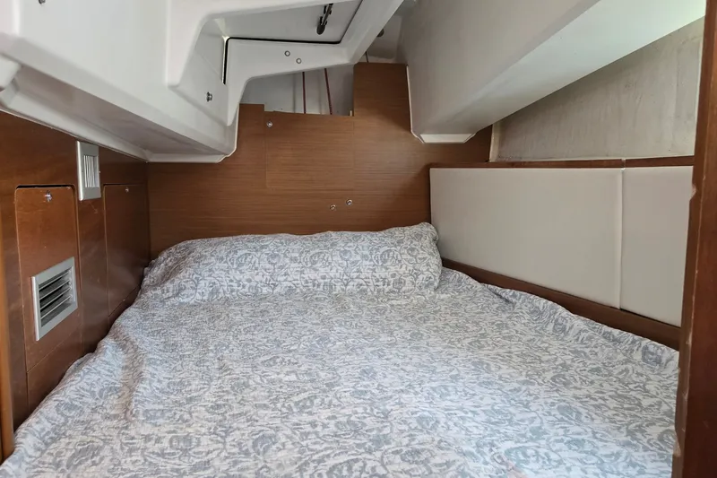 Slide: The Image of Cozy cabin interior of 2020 Jeanneau Sun Odyssey 410 sailboat with patterned bedding. - 57