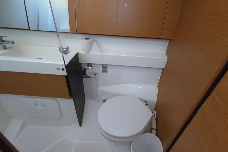 Slide: The Image of Bathroom interior of 2020 Jeanneau Sun Odyssey 410 yacht, featuring modern fixtures and wood accents. - 53
