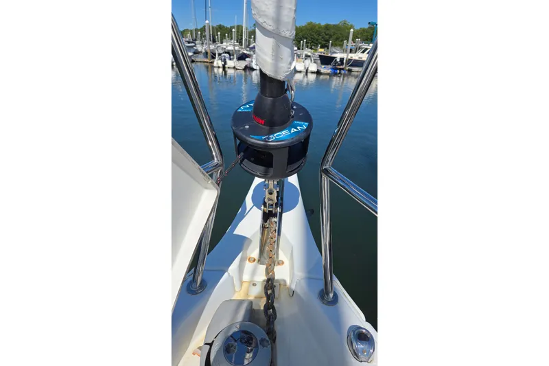 Slide: The Image of Jeanneau Sun Odyssey 410 sailboat bow with anchor chain and marina view, 2020 model. - 22