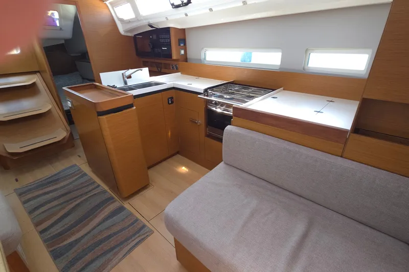 Slide: The Image of Interior of 2020 Jeanneau Sun Odyssey 410 yacht, featuring modern kitchen and seating area. - 42