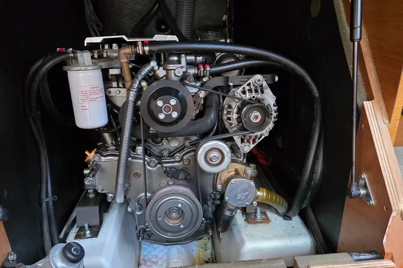 Slide: The Image of Engine compartment of a 2020 Jeanneau Sun Odyssey 410 sailboat, showcasing mechanical components. - 58