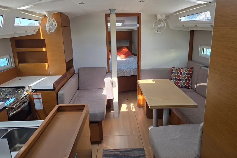 Slide: The Image of Interior of 2020 Jeanneau Sun Odyssey 410 yacht with modern furnishings and cozy seating area. - 26