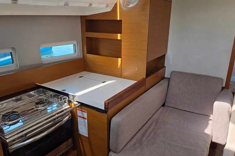 Slide: The Image of Interior of 2020 Jeanneau Sun Odyssey 410 yacht with kitchen and seating area. - 35