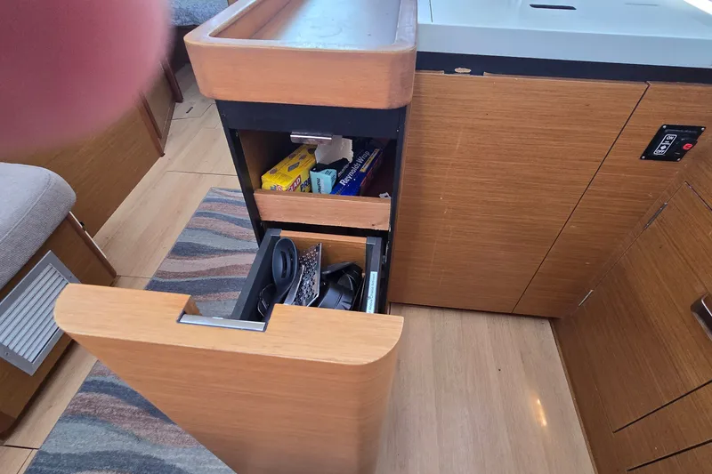 Slide: The Image of Interior of 2020 Jeanneau Sun Odyssey 410 showing open kitchen drawers. - 49