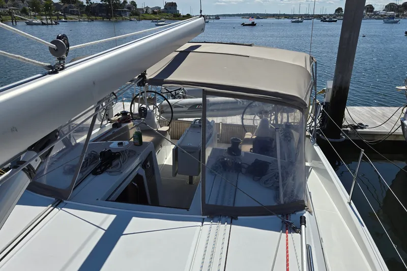 Slide: The Image of 2020 Jeanneau Sun Odyssey 410 sailboat docked at marina, featuring spacious cockpit and canopy. - 24