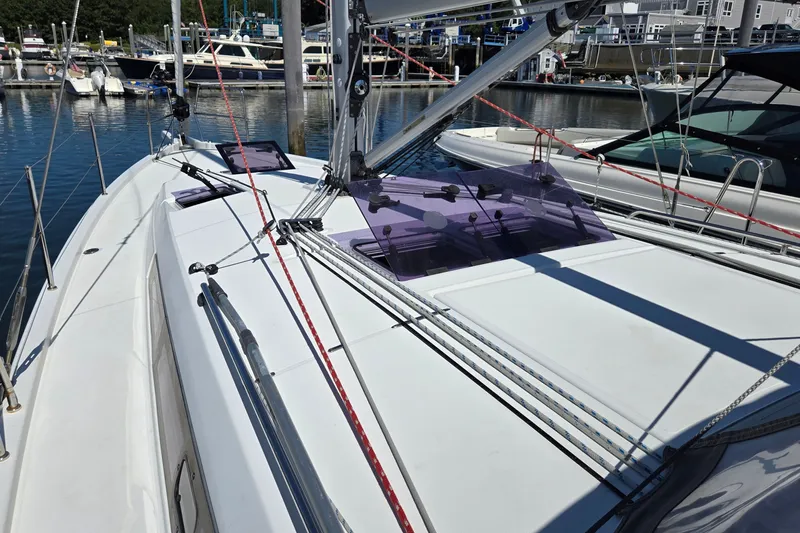 Slide: The Image of 2020 Jeanneau Sun Odyssey 410 sailboat deck with rigging in a marina. - 15
