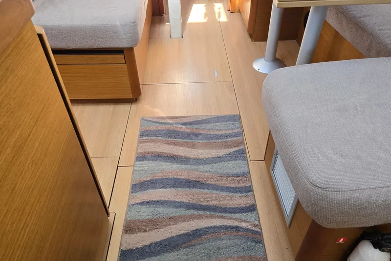 Slide: The Image of Interior of 2020 Jeanneau Sun Odyssey 410 with wooden flooring and cozy seating. - 32
